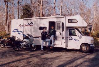 A picture of Christine and Joe in front of their RV.